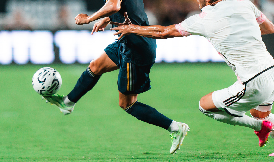 Two players contesting the ball during a match